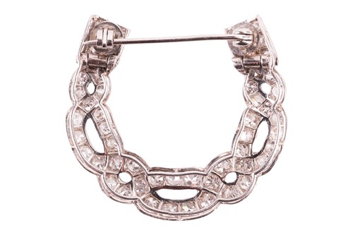 Lot 17 - A diamond horseshoe brooch, in a twisted...