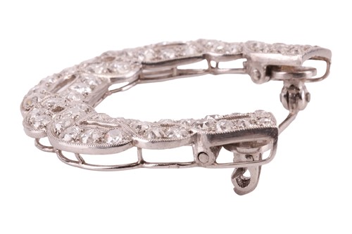 Lot 17 - A diamond horseshoe brooch, in a twisted...