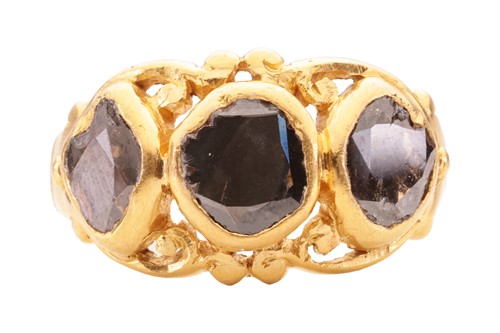 Lot 148 - A three stone high carat gold ring, featuring...