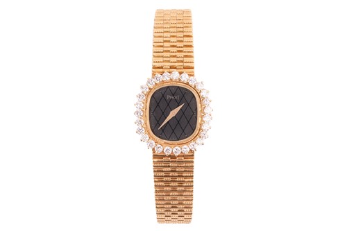 Lot 172 - A Piaget Diamond set dress watch in 18ct gold....