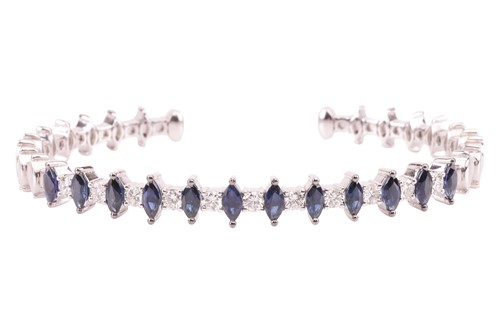 Lot 9 - A sapphire and diamond bangle; comprising...