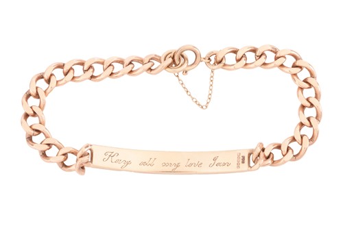 Lot An engraved ID bracelet in 9ct yellow gold,...