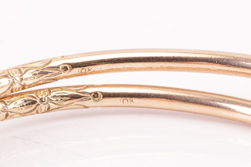 Lot 22 - A pair of textured torque bangles, chased with...