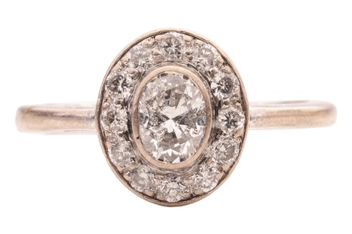 Lot A diamond cluster ring, featuring an oval-cut...