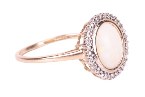 Lot 66 - An opal dress ring in 9ct yellow gold, centred...