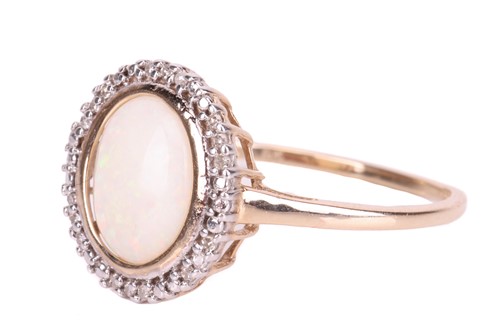 Lot 66 - An opal dress ring in 9ct yellow gold, centred...