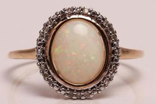 Lot 66 - An opal dress ring in 9ct yellow gold, centred...