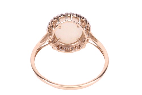 Lot 66 - An opal dress ring in 9ct yellow gold, centred...