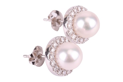 Lot 92 - A pair of pearl and diamond halo earrings by...