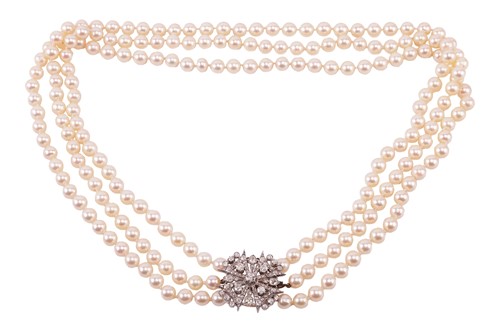 Lot 142 - A three strand cultured pearl necklace with an...