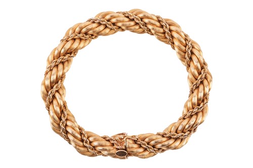 Lot 51 - A yellow metal bracelet, of twisted rope form,...
