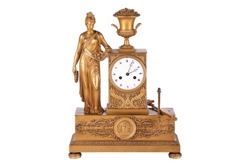 Lot 158 - A French Empire gilt-metal mantel clock, the...