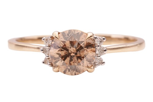Lot 44 - A brown diamond solitaire ring, set with a...