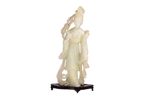 Lot 167 - A large Chinese-carved light green jade figure...