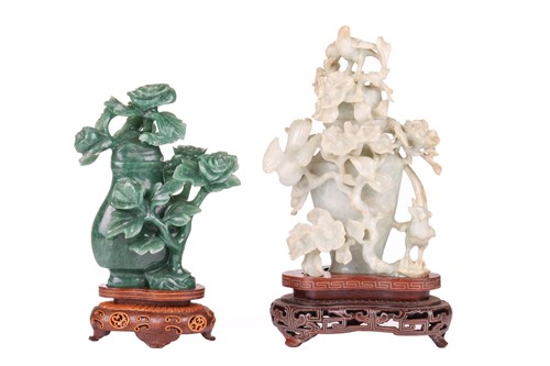 Lot 173 - A Chinese carved light grey, green jade flower...