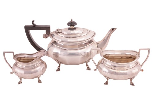 Lot 253 - A silver three piece tea set, of oval form,...