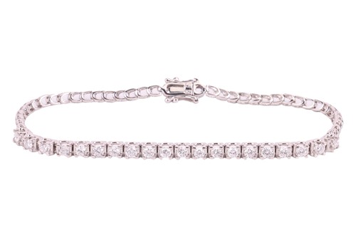 Lot 12 - A diamond-set line bracelet, set with twenty...