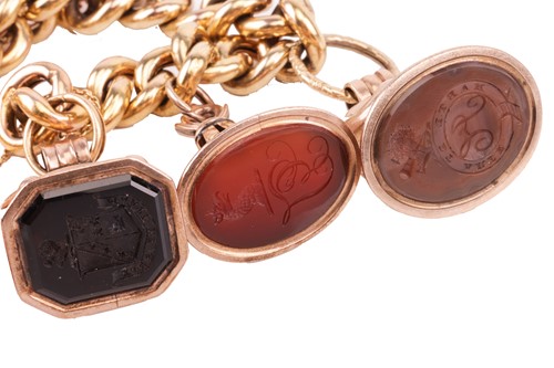 Lot 115 - A 15ct gold charm bracelet, the 15ct flat curb-...