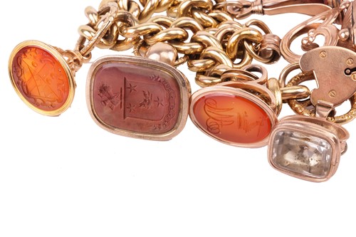 Lot 115 - A 15ct gold charm bracelet, the 15ct flat curb-...