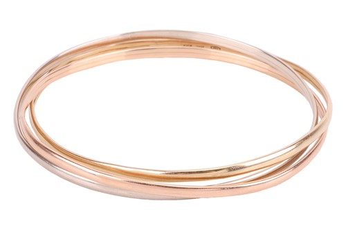 Lot 110 - A trinity bangle in 18ct gold, formed of three...