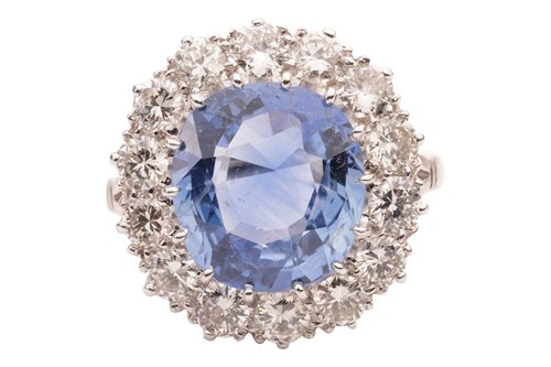 Lot 132 - A sapphire and diamond cluster ring, the...