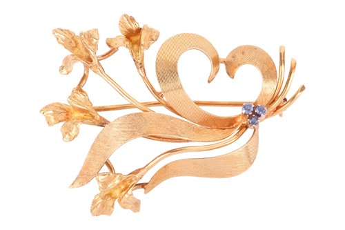 Lot 17 - A sapphire-set floral spray brooch in 18ct...