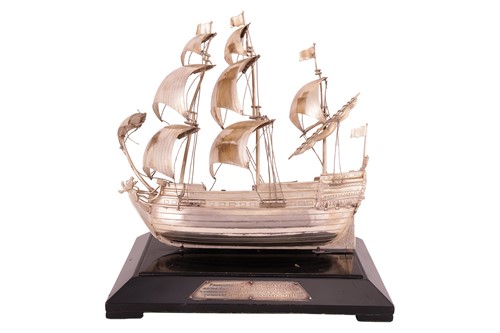 Lot 215 - A silver boat on an ebonised stand with silver...