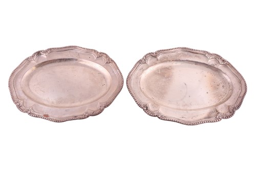 Lot 238 - A pair of George III silver serving platters...