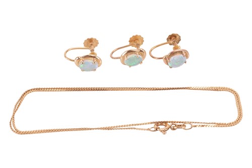 Lot 23 - Three opal earrings, each claw-set with an...