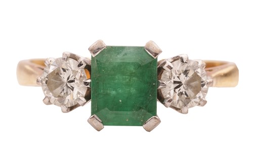 Lot 73 - An emerald and diamond trilogy ring in 18ct...