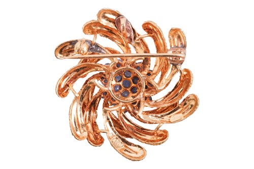 Lot 14 - An enamelled swirl brooch set with sapphires,...