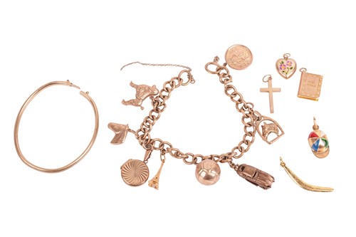 Lot 29 - A 1960s 9ct gold charm bracelet, with a flat...