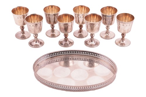 Lot 299 - A set of eight heavily turned silver goblets...