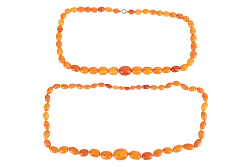 Lot 83 - Two amber bead necklaces; a row of...