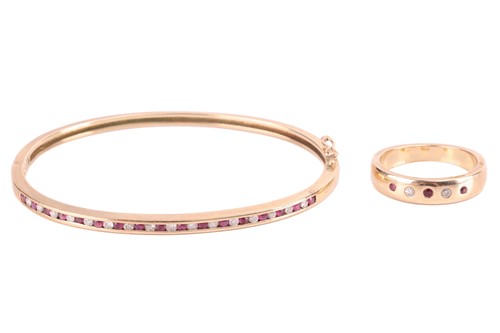 Lot 165 - A ruby and diamond set hinged bangle and band...