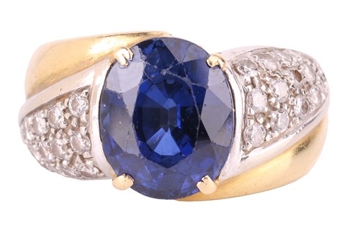 Lot A gem-set dress ring, centred with an oval-cut...