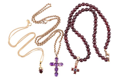 Lot 52 - Three gem-set necklaces; to include a cross...