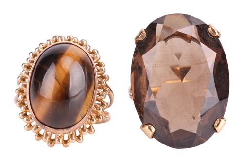 Lot 134 - Two gem-set dress rings; the oval tiger's eye...