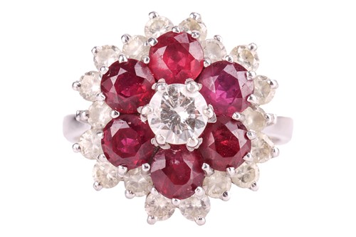 Lot 24 - A ruby and diamond cluster ring, centred with...