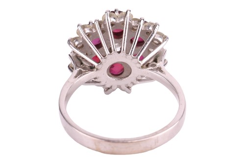 Lot 24 - A ruby and diamond cluster ring, centred with...