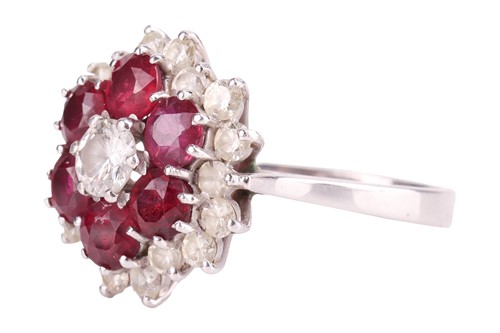 Lot 24 - A ruby and diamond cluster ring, centred with...