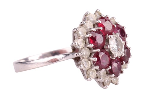 Lot 24 - A ruby and diamond cluster ring, centred with...