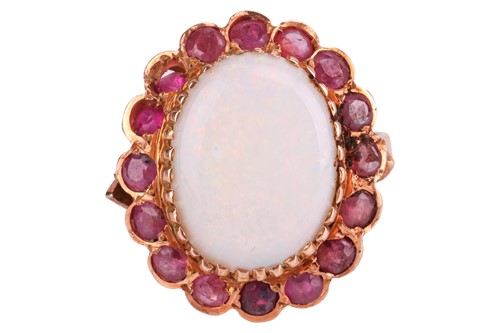 Lot 101 - An opal and ruby cluster ring, centred with an...