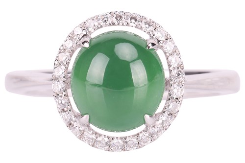 Lot 35 - A jade and diamond halo ring, centred with an...