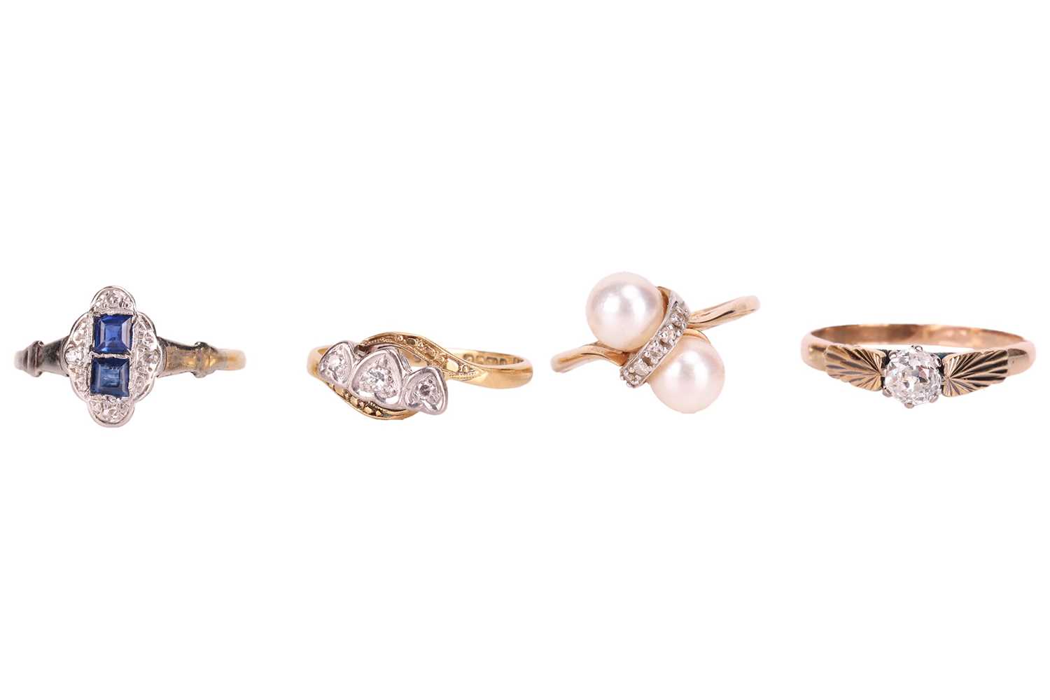 Lot 85 - Four gem-set rings; to include a three-stone...