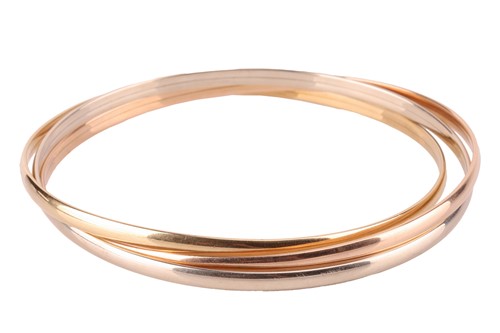 Lot 109 - A trinity bangle in 18ct gold, formed of three...