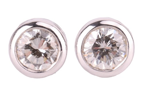 Lot A pair of diamond stud earrings, bezel-set...