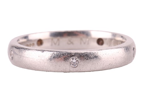 Lot A diamond-set wedding band in platinum, the...