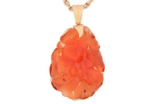 Lot 139 - A carved carnelian pendant on chain, the large...