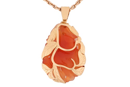 Lot 139 - A carved carnelian pendant on chain, the large...